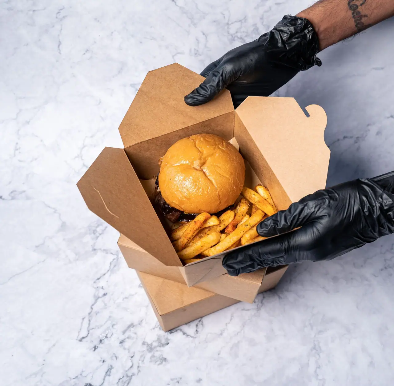 Burger and fries packed in a kraft box