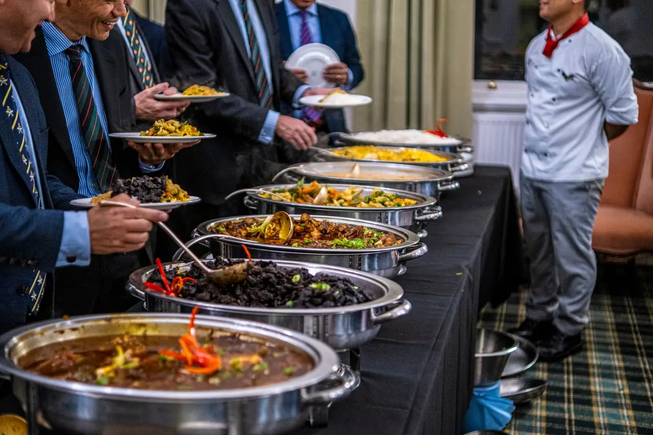 Guests serving themselves at a catered buffet