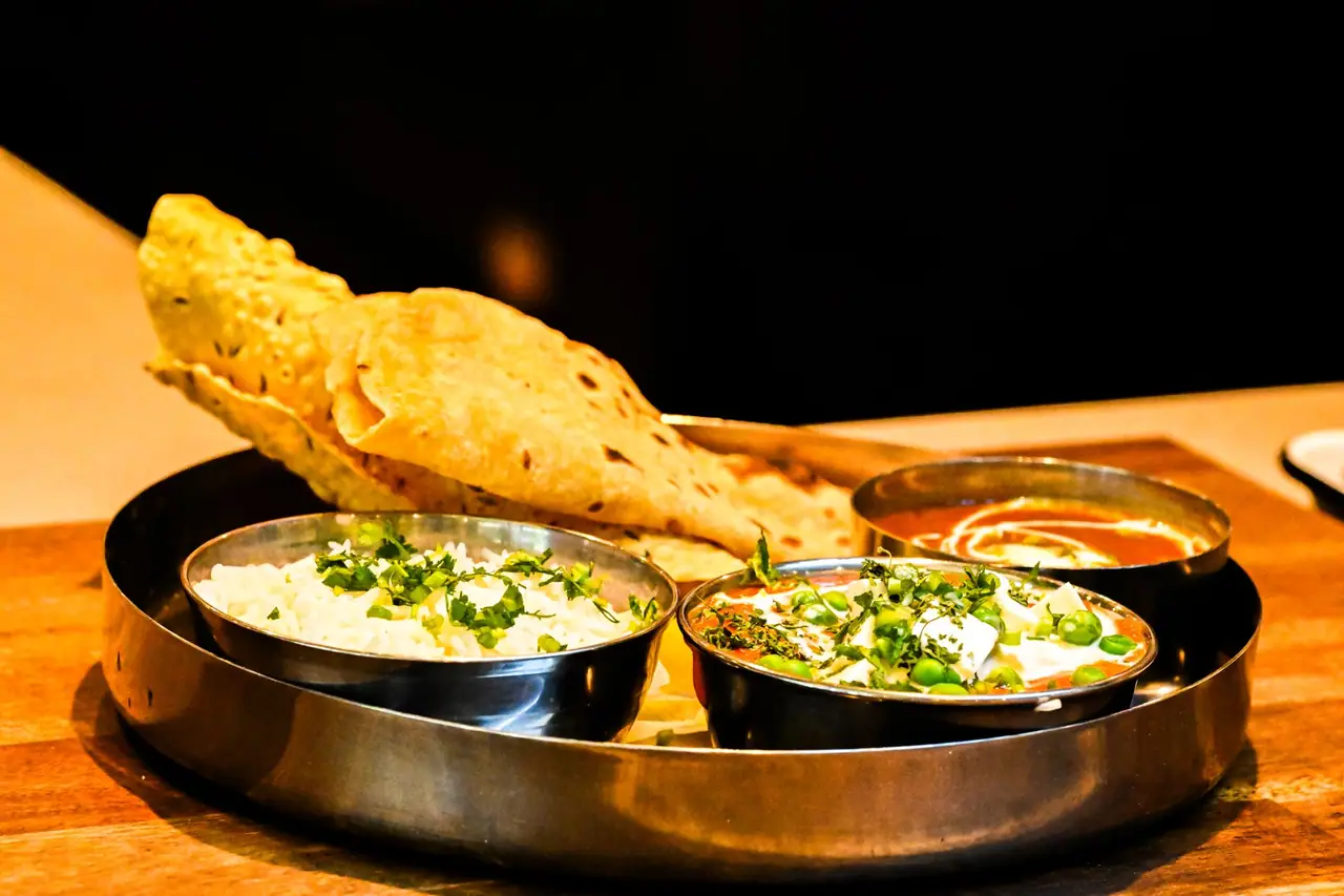 North Indian curries and naan on a steel thali