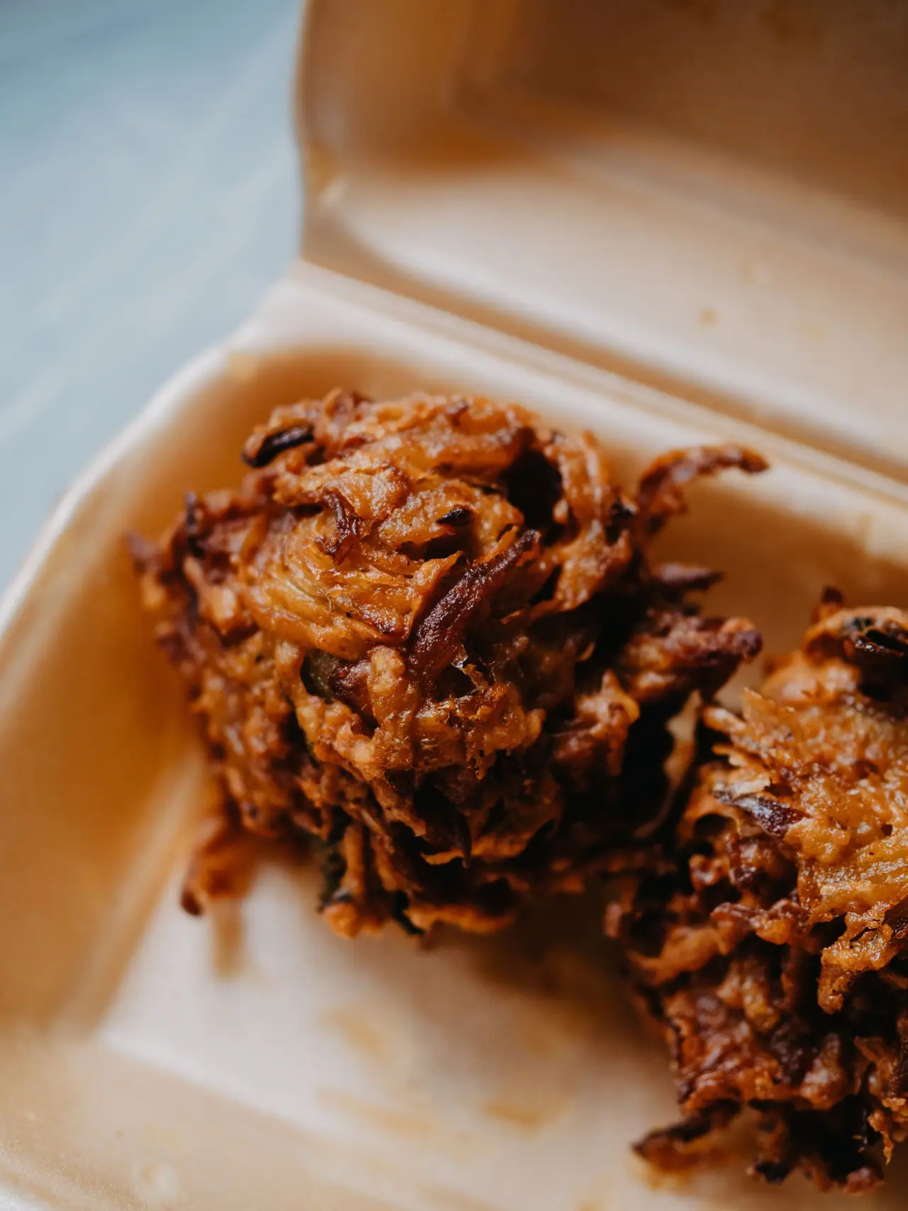 Onion bhajis in a takeaway container